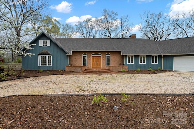 1476 New Market Rd, Tryon, NC 28782 - view of front of property featuring a shingled roof, a chimney, a garage, and dirt driveway