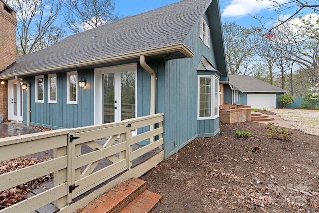 1476 New Market Rd, Tryon, NC 28782 - view of front of property featuring a chimney, board and batten siding, french doors, driveway, and roof with shingles