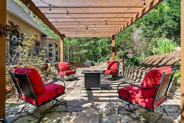 view of patio / terrace with a pergola and an outdoor fire pit