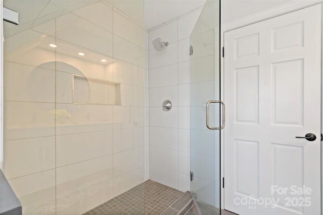 bathroom with a stall shower and recessed lighting