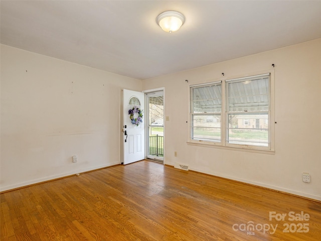 12 Birchwood Ln, Asheville, NC 28805 - unfurnished room with wood finished floors, baseboards, and visible vents