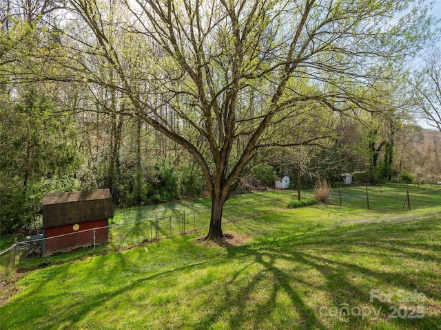 12 Birchwood Ln, Asheville, NC 28805 - view of yard with a storage shed, fence, an outdoor structure, and a view of trees