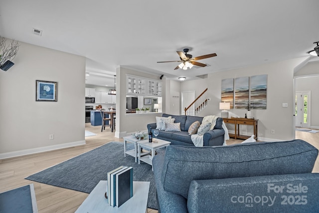 1809 Robbins Meadows Dr, Waxhaw, NC 28173 - living room featuring ceiling fan, light wood finished floors, and stairs