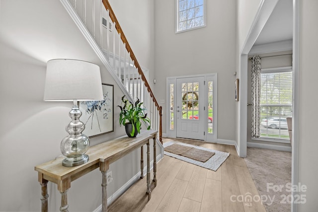 1809 Robbins Meadows Dr, Waxhaw, NC 28173 - foyer entrance with a towering ceiling, plenty of natural light, stairs, and wood finished floors