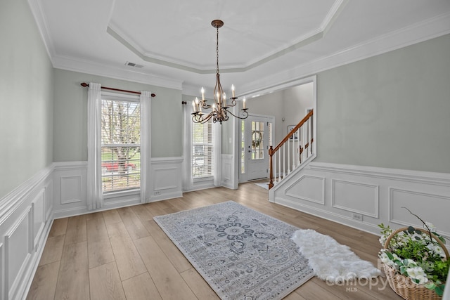 1809 Robbins Meadows Dr, Waxhaw, NC 28173 - entrance foyer with a chandelier, a raised ceiling, light wood finished floors, a decorative wall, and stairway