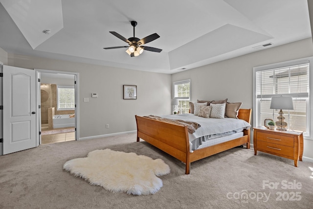 1809 Robbins Meadows Dr, Waxhaw, NC 28173 - bedroom with light carpet, multiple windows, a tray ceiling, and ensuite bath