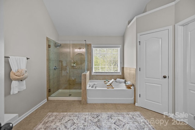 1809 Robbins Meadows Dr, Waxhaw, NC 28173 - bathroom with vaulted ceiling, tile patterned floors, a bath, and a stall shower