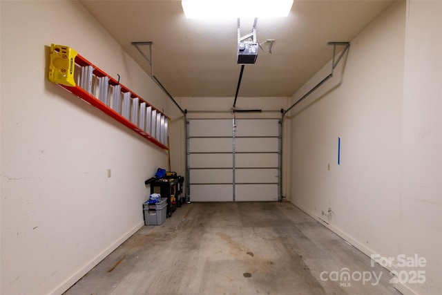 226 Sawgrass Dr Unit 3, Whittier, NC 28789 - garage featuring baseboards and a garage door opener
