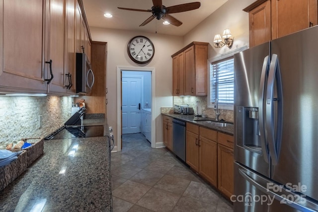 226 Sawgrass Dr Unit 3, Whittier, NC 28789 - kitchen with a ceiling fan, brown cabinets, dark stone counters, appliances with stainless steel finishes, and a sink