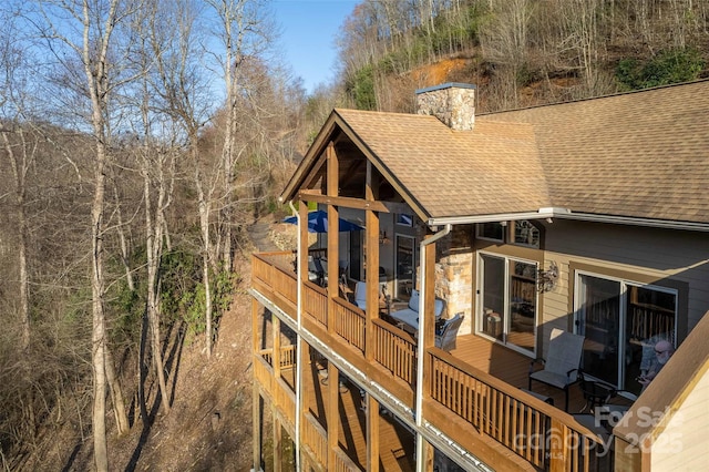 226 Sawgrass Dr Unit 3, Whittier, NC 28789 - rear view of house featuring a shingled roof, a deck, and a chimney