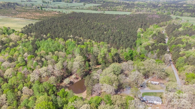 bird's eye view with a wooded view