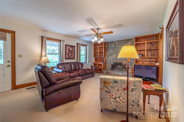 207 New Orleans Blvd, Morganton, NC 28655 - carpeted living room with visible vents, a ceiling fan, baseboards, a textured ceiling, and built in features