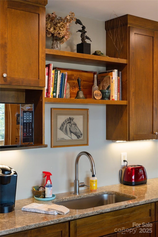 263 Mine Cove Rd, Spruce Pine, NC 28777 - kitchen featuring stainless steel microwave, brown cabinets, a sink, and open shelves