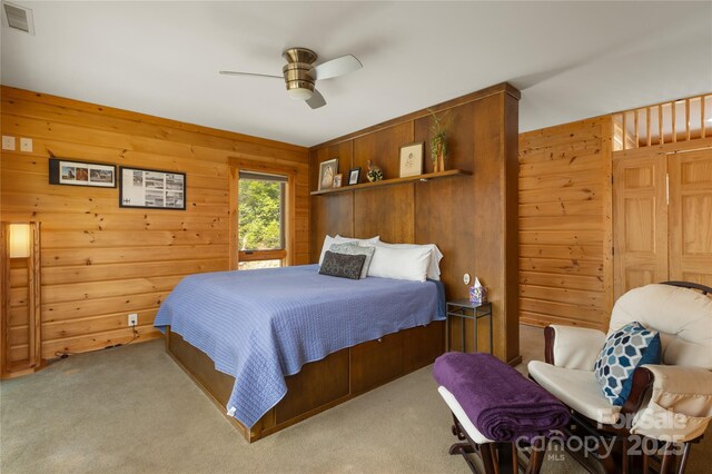 263 Mine Cove Rd, Spruce Pine, NC 28777 - bedroom with wood walls, carpet, visible vents, and ceiling fan
