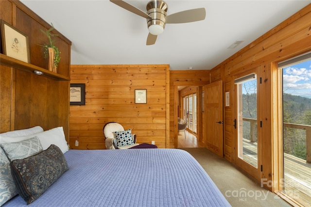 263 Mine Cove Rd, Spruce Pine, NC 28777 - bedroom with light colored carpet, ceiling fan, visible vents, wooden walls, and access to outside