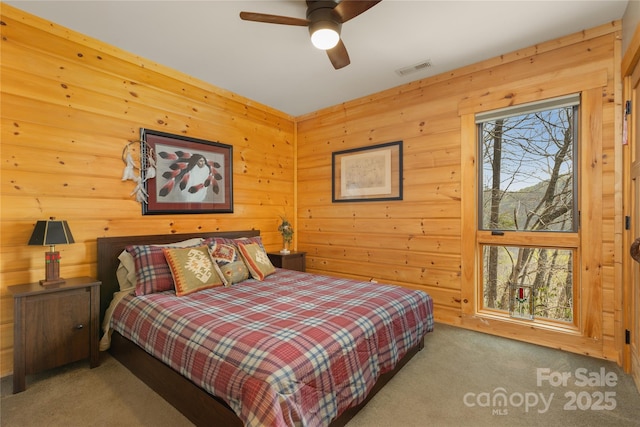 263 Mine Cove Rd, Spruce Pine, NC 28777 - carpeted bedroom featuring visible vents and wooden walls