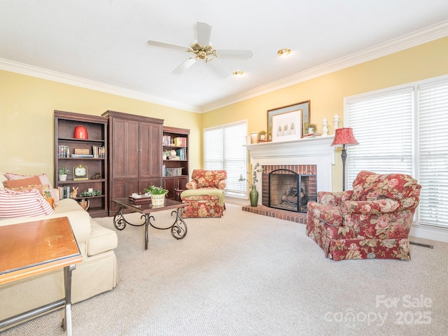 carpeted living area with crown molding, visible vents, a ceiling fan, and a fireplace
