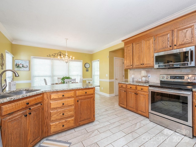 kitchen with an inviting chandelier, tasteful backsplash, ornamental molding, appliances with stainless steel finishes, and a sink