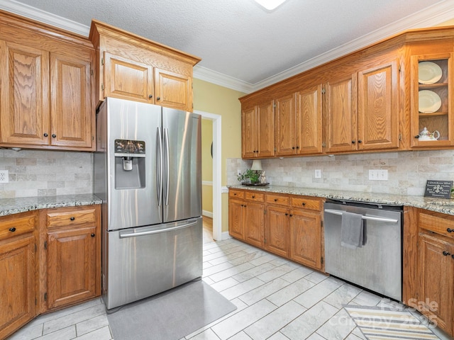 kitchen featuring brown cabinetry, tasteful backsplash, and stainless steel appliances