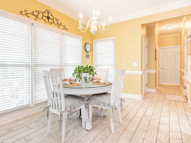 dining room featuring crown molding, a notable chandelier, and baseboards