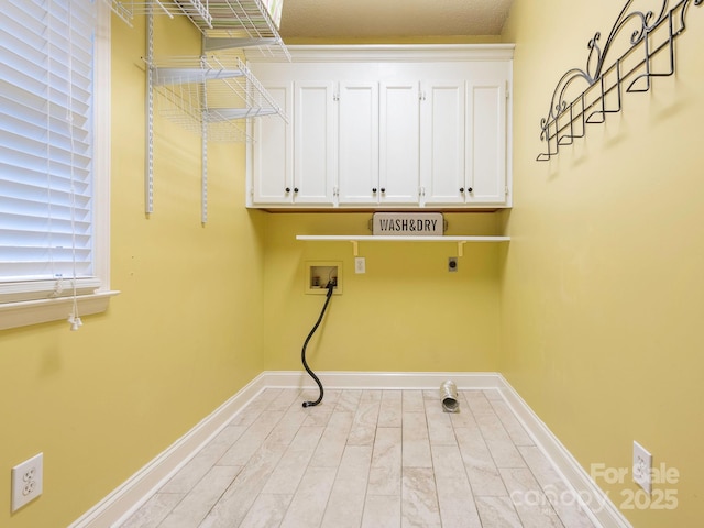 laundry area featuring hookup for an electric dryer, baseboards, hookup for a washing machine, and cabinet space