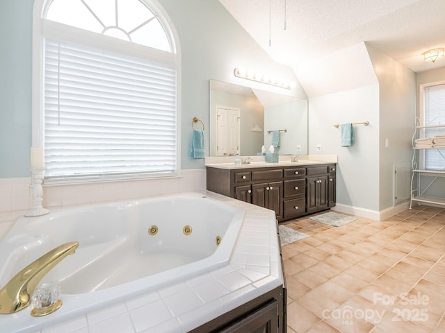 bathroom featuring a sink, a whirlpool tub, a wealth of natural light, and lofted ceiling
