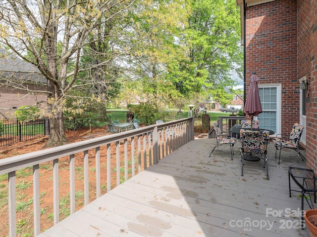 deck featuring fence and outdoor dining area