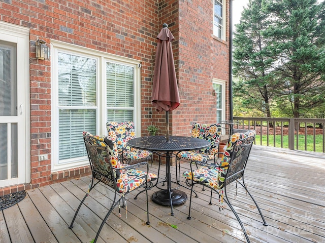 wooden terrace featuring outdoor dining area