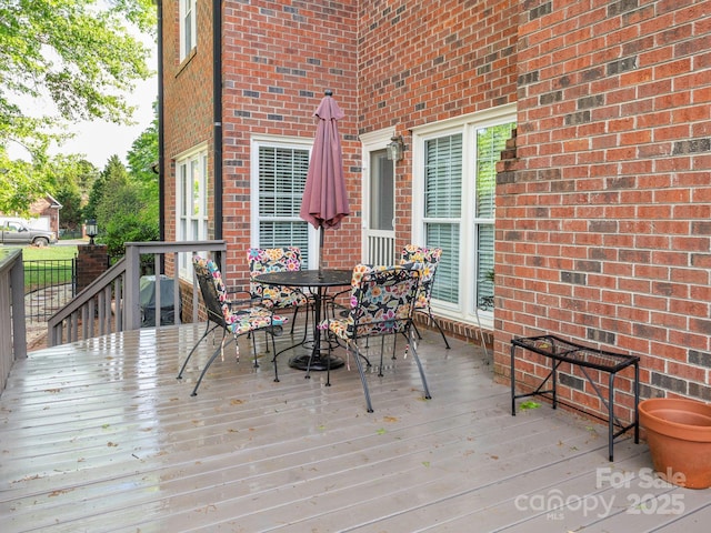 deck with outdoor dining area