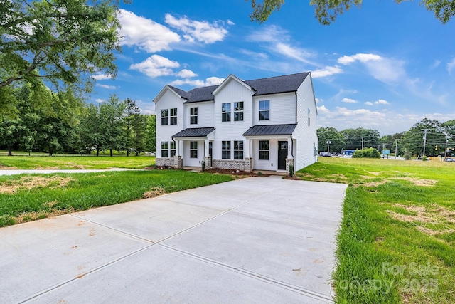 304AND306 Buford Dr, Landis, NC 28088 - view of front of house featuring a standing seam roof, a metal roof, driveway, a front lawn, and roof with shingles