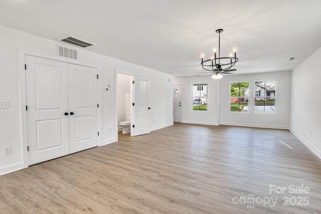 304AND306 Buford Dr, Landis, NC 28088 - unfurnished living room featuring a chandelier and wood finished floors