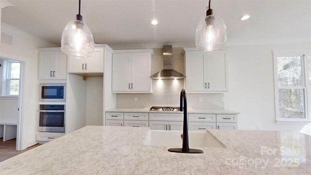 472 Bellingshire Dr, Mount Ulla, NC 28125 - kitchen featuring a sink, white cabinets, wall chimney exhaust hood, and stainless steel appliances