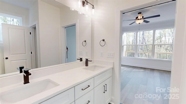 472 Bellingshire Dr, Mount Ulla, NC 28125 - full bath with wood finished floors, double vanity, a sink, and ceiling fan