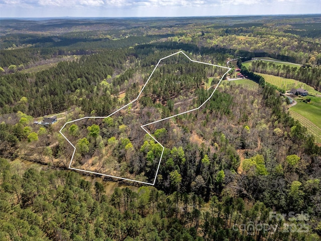 bird's eye view featuring a wooded view