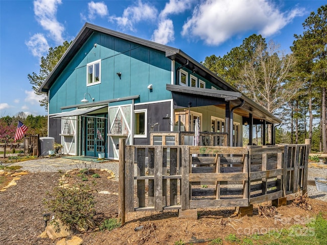 rear view of property with an exterior structure and an outdoor structure