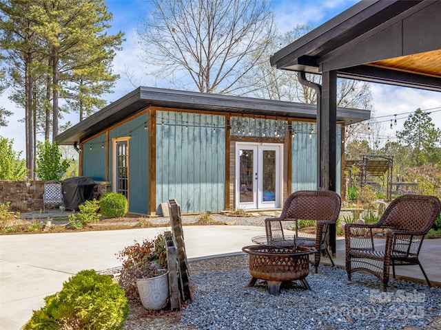 view of patio / terrace featuring an outdoor fire pit, area for grilling, and french doors