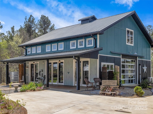 rear view of property with a standing seam roof, metal roof, and french doors