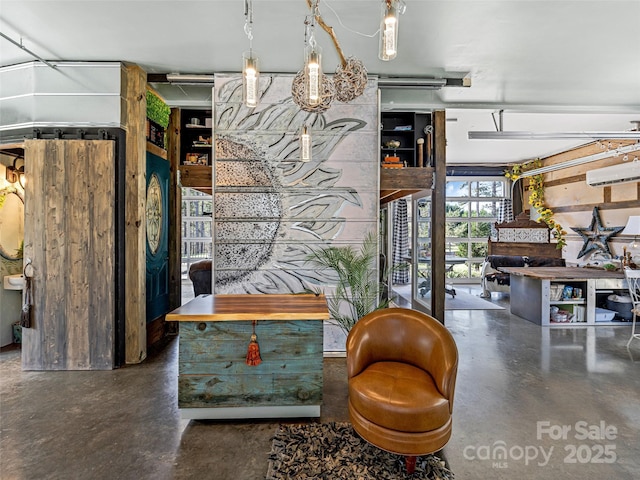 interior space featuring a wall mounted AC and concrete floors