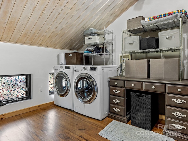 laundry room with baseboards, washer and clothes dryer, laundry area, wood ceiling, and wood finished floors