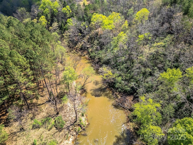 birds eye view of property with a wooded view