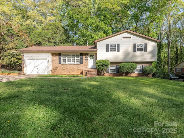 split level home with an attached garage, concrete driveway, a front lawn, and brick siding
