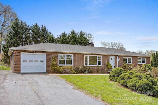 ranch-style home with brick siding, driveway, and an attached garage
