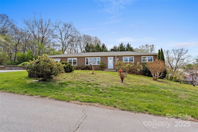 single story home with a front lawn and brick siding