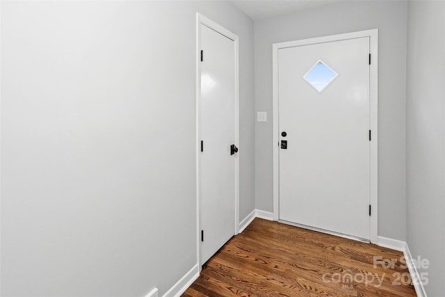 entrance foyer with baseboards and wood finished floors
