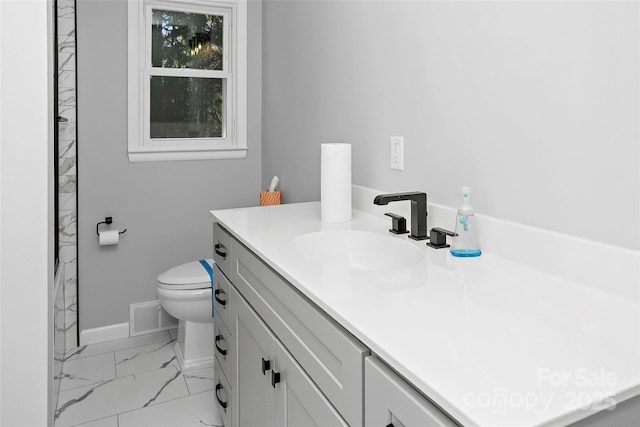 bathroom with vanity, baseboards, toilet, visible vents, and marble finish floor