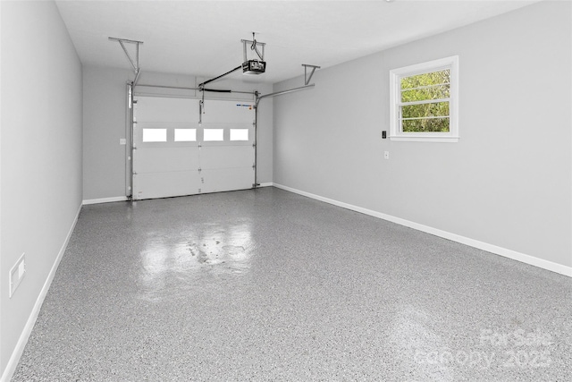 garage with a garage door opener and baseboards