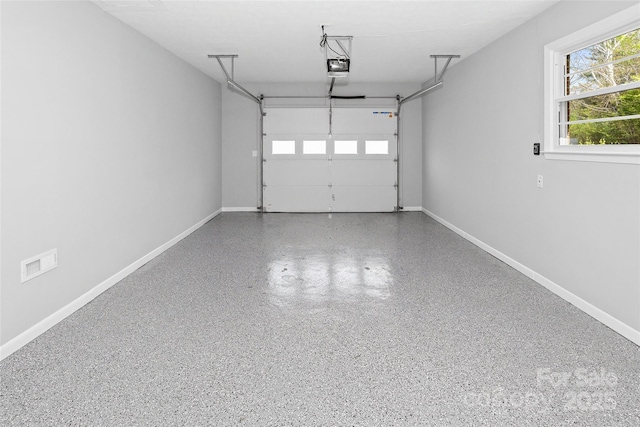 garage featuring baseboards and a garage door opener