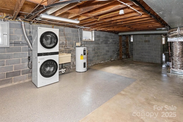 unfinished basement with water heater, a sink, and stacked washer and clothes dryer