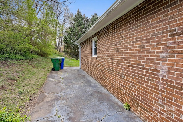 view of property exterior with brick siding