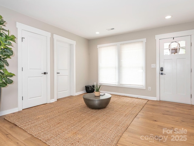 entryway featuring light wood-style floors, baseboards, and recessed lighting
